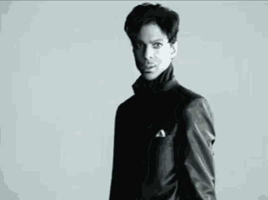 a black and white photo of a man in a leather jacket