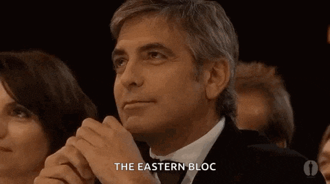 a man in a suit and tie is sitting in a crowd and says the eastern bloc .