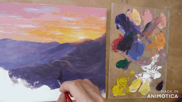 a painting of a sunset is being painted on a canvas with the words made in animotica below it