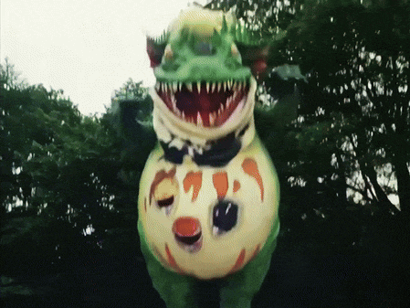 a green and yellow monster with a huge mouth