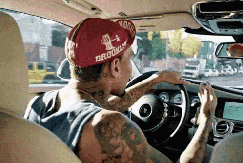 a man wearing a red hat that says brooklyn on it