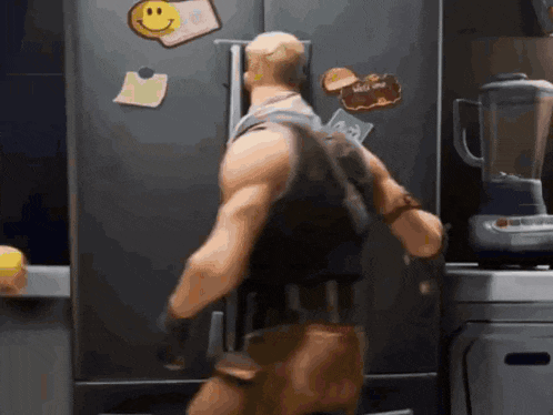 a man is standing in front of a refrigerator with a smiley face on the door