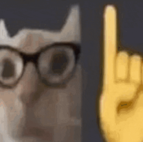 a close up of a cat wearing glasses next to a yellow hand making a horns sign .
