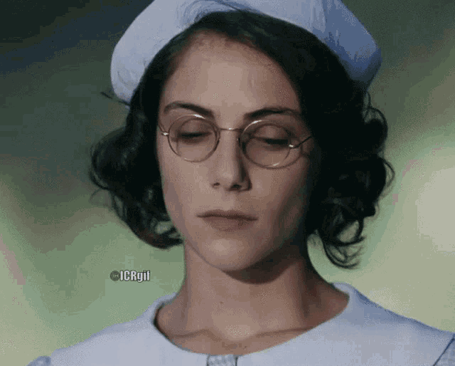 a close up of a woman wearing glasses and a nurse 's hat with the words icrgif below her