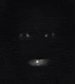 a close up of a person 's eyes in the dark
