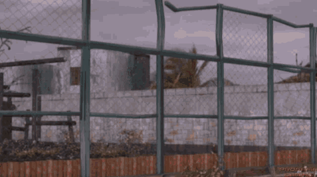 a woman in a bikini is standing in front of a chain link fence with the word proactive on the bottom