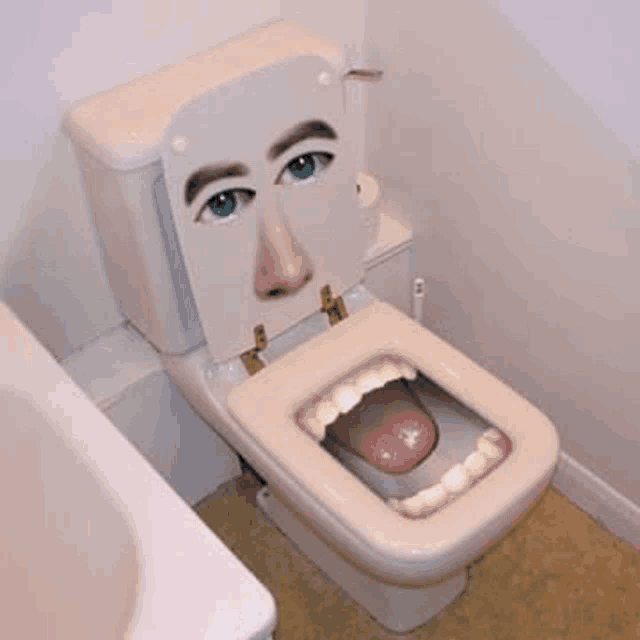 a toilet with a picture of a man 's face on the seat and tongue sticking out .
