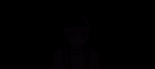 a cartoon girl with purple hair is being held by a person 's hands