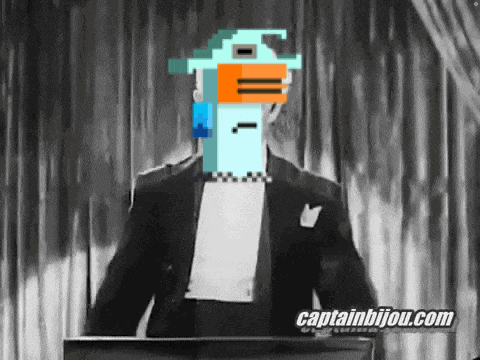 a man in a tuxedo stands at a podium with captainbijou.com written on the bottom right