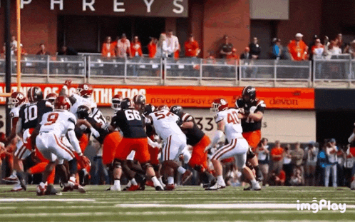 a football game is being played in front of a sign that says phrey 's