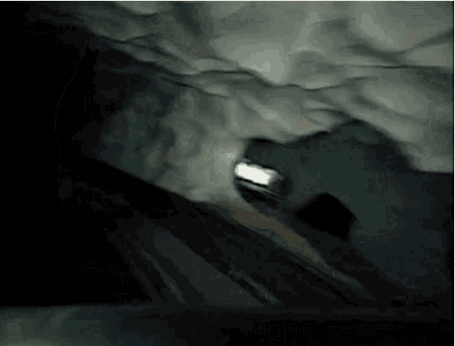 a man wearing a headlamp is walking down a snowy hill