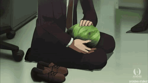 a man in a suit and tie is kneeling down holding a cabbage
