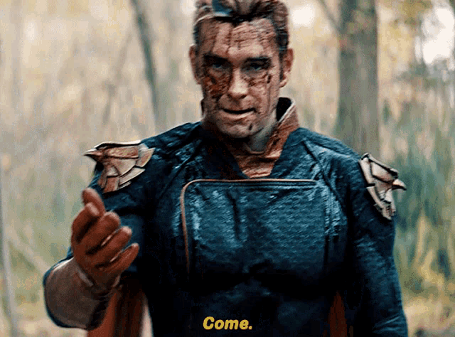 a man in a superhero costume with blood on his face says come