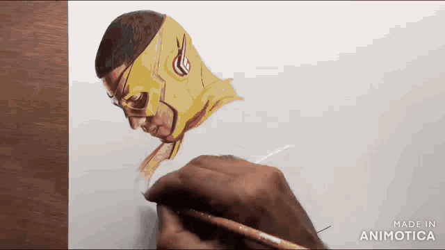 a person is drawing a superhero with a yellow mask on their head