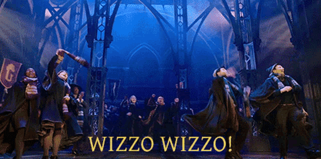 a group of people are dancing on a stage with the words wizzo wizzo on the bottom