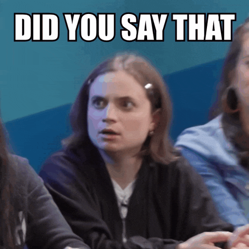 a woman with a surprised look on her face sits in front of a sign that says " did you say that "