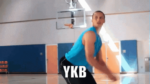 a man on a basketball court with the word ykb written on the floor