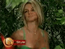 a woman in a green tank top is standing in front of a sign that says ' style '