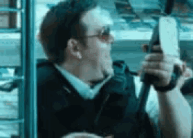 a man in sunglasses is holding a gun in his hand