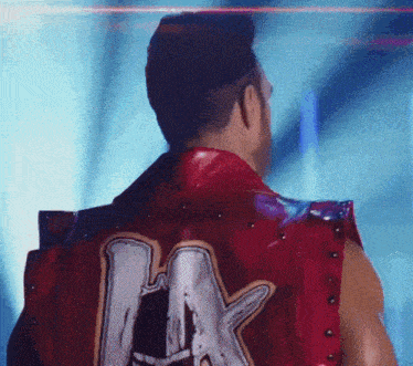 a man wearing a red vest with the letter a on the back