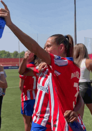 a female soccer player wearing a red and white striped shirt with the number 7 on the back