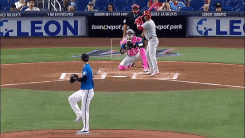 a baseball game is being played in front of an ad for loan depot park