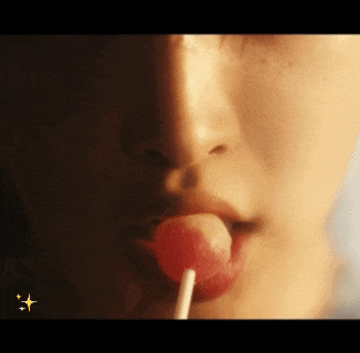 a close up of a person eating a lollipop