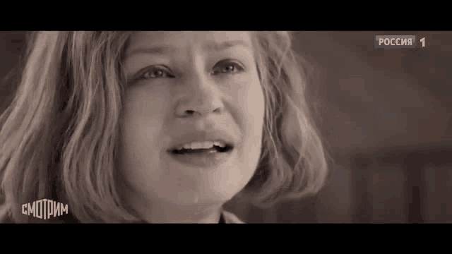 a close up of a woman 's face with a tear running down her face
