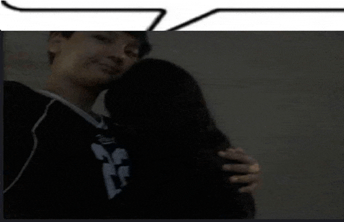 a man wearing a number 23 jersey hugs a woman