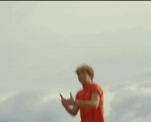 a person is jumping in the air while another person holds a yellow item