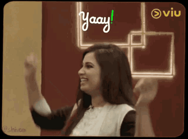 a woman with her arms in the air and the word yaay written in green