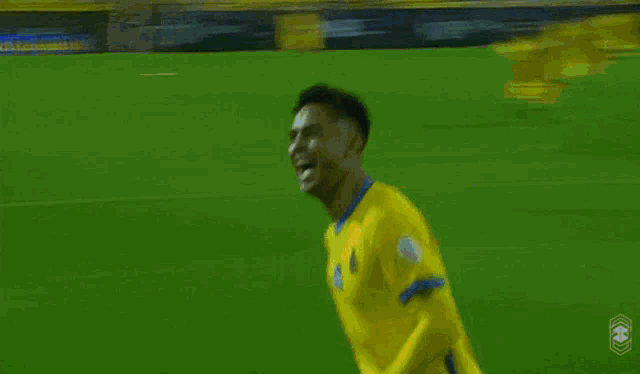 a soccer player wearing a yellow jersey with the number 10