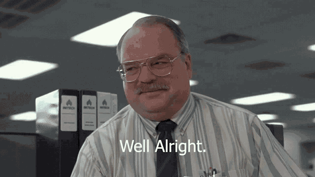 a man with glasses and a mustache says " well alright "