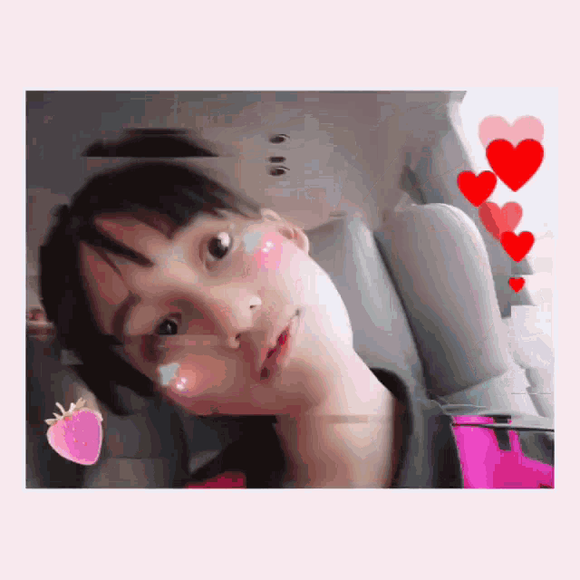 a girl with a strawberry on her cheek