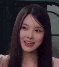a close up of a woman 's face with long hair .