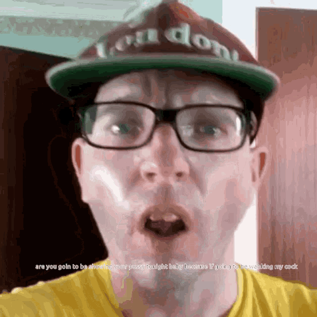 a man wearing glasses and a london hat