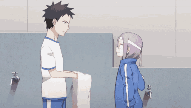a boy and a girl are standing next to each other
