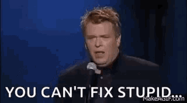 a man is holding a glass of whiskey in front of a microphone and says `` you can 't fix stupid '' .