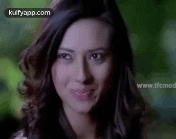 a close up of a woman 's face making a funny face .
