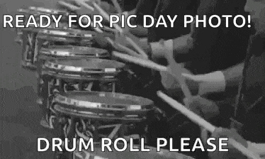 a group of people are playing drums in a band .