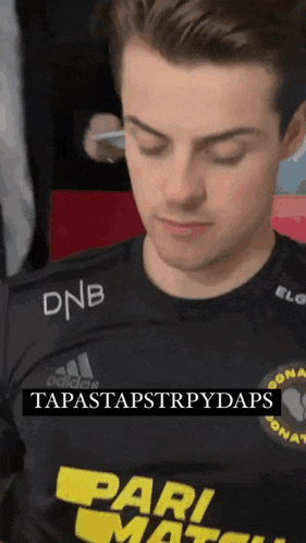 a man wearing a black shirt with dnb on it