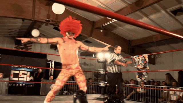 a man in a clown costume is in a wrestling ring with a csw sign behind him