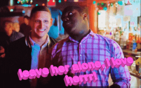 a man standing next to another man with the words " leave her alone i love her " on the bottom