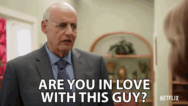 a man in a suit and tie says " are you in love with this guy ? "
