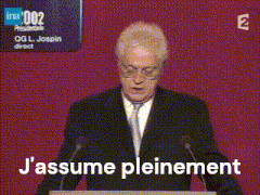 a man in a suit and tie is giving a speech