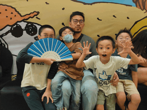 a group of young boys are posing for a picture and one of them is wearing a shirt that says ' gap ' on it