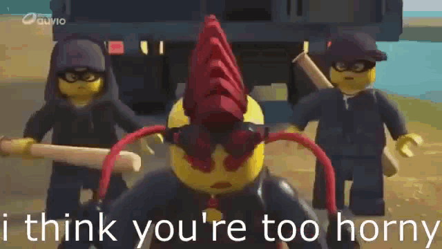 a group of lego figures are standing next to each other and one of them is holding a stick .