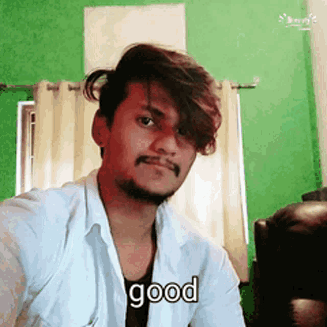 a man in a white shirt is taking a selfie and the word good is on the bottom
