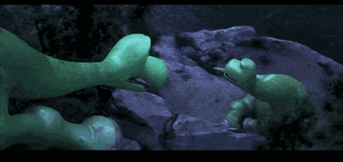 two green monsters are standing next to each other