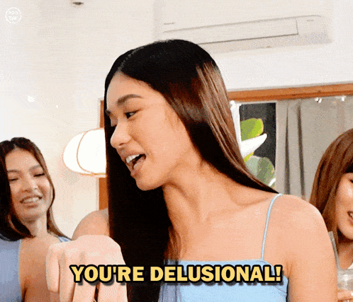 a woman says " you 're delusional " in front of a group of girls
